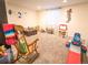 Spacious playroom with plush carpeting, ample room for toys, and natural light at 5626 S Biloxi Way, Aurora, CO 80016