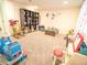 The playful playroom with plush carpeting, features toys, a rocking chair and ample space to play at 5626 S Biloxi Way, Aurora, CO 80016