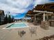 Community pool with a covered outdoor kitchen and seating area for residents to enjoy on a sunny day at 5626 S Biloxi Way, Aurora, CO 80016