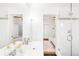 Bright bathroom with a double sink vanity, glass shower, and a view into the bedroom at 1061 Adams St, Denver, CO 80206