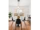 Bright dining area with pendant lighting, black chairs, hardwood floors, with an outside view at 1061 Adams St, Denver, CO 80206
