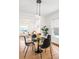 Charming dining area with pendant lighting, black chairs, and hardwood floors, flowing into the inviting living room at 1061 Adams St, Denver, CO 80206