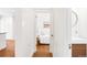 Hallway view with wood floors and a bedroom and bathroom in the background, creating a seamless flow in the home at 1061 Adams St, Denver, CO 80206