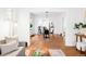 Open-concept living room with hardwood floors, a modern sofa, and view to a dining area and a bright kitchen at 1061 Adams St, Denver, CO 80206