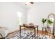 Bright home office with a desk, chair, mirror, and stylish décor, providing a functional and aesthetically pleasing workspace at 1061 Adams St, Denver, CO 80206