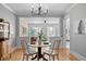 Charming dining area featuring hardwood floors, modern lighting, and inviting view of the living space with exposed brick at 529 E 14Th Ave # 10, Denver, CO 80203