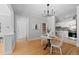Well-lit dining area next to kitchen featuring hardwood floors and elegant lighting fixture, adjacent to kitchen at 529 E 14Th Ave # 10, Denver, CO 80203