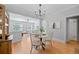 Bright dining room features hardwood floors, modern chandelier, and open access to living room for easy entertaining at 529 E 14Th Ave # 10, Denver, CO 80203