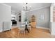 Dining area with hardwood floors, a chandelier, and views into the kitchen at 529 E 14Th Ave # 10, Denver, CO 80203