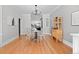 Dining room featuring hardwood floors, modern lighting, and an open layout to the kitchen at 529 E 14Th Ave # 10, Denver, CO 80203
