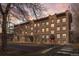 Charming brick apartment building with red doors and awnings, showcasing classic architectural details and a welcoming entrance at 529 E 14Th Ave # 10, Denver, CO 80203
