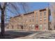 Charming brick apartment building with red doors and awnings, showcasing classic architectural details and a welcoming entrance at 529 E 14Th Ave # 10, Denver, CO 80203