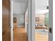 Hallway view showcasing an open concept living room with a brick wall and hardwood floors at 529 E 14Th Ave # 10, Denver, CO 80203