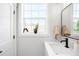 Well-lit bathroom featuring a modern sink, mirror, and decorative accessories at 8357 W 68Th Ln, Arvada, CO 80004