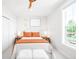 Bright bedroom with hardwood floors, large window, ceiling fan and neutral decor at 8357 W 68Th Ln, Arvada, CO 80004