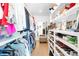 Spacious walk-in closet with built-in shelving and ample storage for clothes and shoes at 8357 W 68Th Ln, Arvada, CO 80004