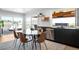 Open dining area with a modern table, chairs, and lots of windows providing natural light at 8357 W 68Th Ln, Arvada, CO 80004