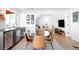 Bright dining area with sleek countertops, a large table with seating for six, and modern decor creating an inviting space at 8357 W 68Th Ln, Arvada, CO 80004
