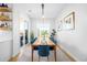 Elegant dining room with a long wooden table and bright blue chairs at 8357 W 68Th Ln, Arvada, CO 80004