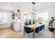 Charming dining room adjacent to the kitchen with a wooden table and bright blue chairs at 8357 W 68Th Ln, Arvada, CO 80004