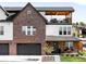 Charming multi-story brick home boasting a rooftop deck and inviting curb appeal at 8357 W 68Th Ln, Arvada, CO 80004