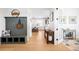 Inviting hallway featuring wood floors, a built-in bench, and a view into the kitchen at 8357 W 68Th Ln, Arvada, CO 80004