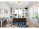 Well-lit home office with built-in bookshelves and a large desk with statement rug at 8357 W 68Th Ln, Arvada, CO 80004