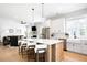 Bright and airy kitchen with a large island, stainless steel appliances, and wood flooring at 8357 W 68Th Ln, Arvada, CO 80004