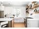 Modern kitchen with white cabinets, stainless steel appliances, and open shelving at 8357 W 68Th Ln, Arvada, CO 80004