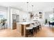 Beautiful kitchen with stainless steel refrigerator, large island with seating, and open shelves at 8357 W 68Th Ln, Arvada, CO 80004