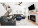 Cozy living room with a leather sectional, fireplace, and modern staircase at 8357 W 68Th Ln, Arvada, CO 80004