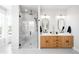 Modern main bathroom features a glass shower, dual sinks, and wood cabinetry at 8357 W 68Th Ln, Arvada, CO 80004