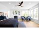 Bright main bedroom features blue accents, sitting area, and large windows at 8357 W 68Th Ln, Arvada, CO 80004