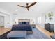 Bright main bedroom features blue accents, a large bed, and neutral paint at 8357 W 68Th Ln, Arvada, CO 80004
