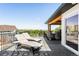 Relaxing outdoor space with lounge chairs, dining area, and scenic views, perfect for enjoying leisure and entertaining at 8357 W 68Th Ln, Arvada, CO 80004