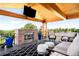 Inviting outdoor area featuring a fireplace, mounted TV, comfortable seating, and a beautiful view for ultimate relaxation at 8357 W 68Th Ln, Arvada, CO 80004