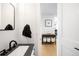 Modern powder room with a black faucet, and a view into the adjacent room at 8357 W 68Th Ln, Arvada, CO 80004