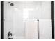 Modern shower with glass enclosure, rainfall shower head, and white subway tile at 8357 W 68Th Ln, Arvada, CO 80004