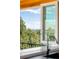 Picturesque view from the kitchen window, showcasing lush trees and a distant skyline, enhancing the home's appeal at 8357 W 68Th Ln, Arvada, CO 80004