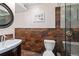 Modern bath boasts wood-look tile, shower with glass door, and vanity sink at 1233 N Ogden St # 610, Denver, CO 80218