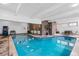 Inviting indoor pool featuring blue water and comfortable lounge area with tables at 1233 N Ogden St # 610, Denver, CO 80218