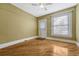 Bedroom with hardwood floors, neutral paint, bright window, ceiling fan and access to the outside at 707 27Th St, Denver, CO 80205