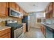 Well-lit kitchen with stainless steel appliances, and ample cabinet space at 707 27Th St, Denver, CO 80205