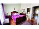 Cozy main bedroom featuring wood floors, a dresser, and access to an ensuite bathroom at 18234 E Arizona Ave # E, Aurora, CO 80017