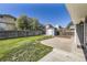 Well-maintained backyard with lush lawn, fenced perimeter, storage shed, and concrete patio at 7814 W Ontario Pl, Littleton, CO 80128