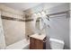 Bathroom with a shower/tub, tile details, and a modern light fixture at 7814 W Ontario Pl, Littleton, CO 80128