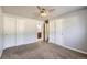 Bedroom with two double closets, neutral carpet, and an attached bathroom for added convenience at 7814 W Ontario Pl, Littleton, CO 80128