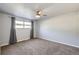 Neutral bedroom featuring soft carpet, ceiling fan, and natural light from a window at 7814 W Ontario Pl, Littleton, CO 80128