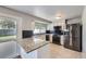 Kitchen with granite counters, stainless appliances, subway tile and access to the backyard at 7814 W Ontario Pl, Littleton, CO 80128