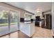 Modern kitchen with stainless steel appliances, granite counters and access to a patio through sliding doors at 7814 W Ontario Pl, Littleton, CO 80128